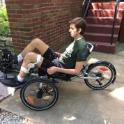 Brad using his trike that was given by MO KIDS