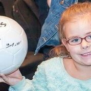 Kenzie with a signed soccer ball