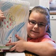 Kenzie with a picture she drew